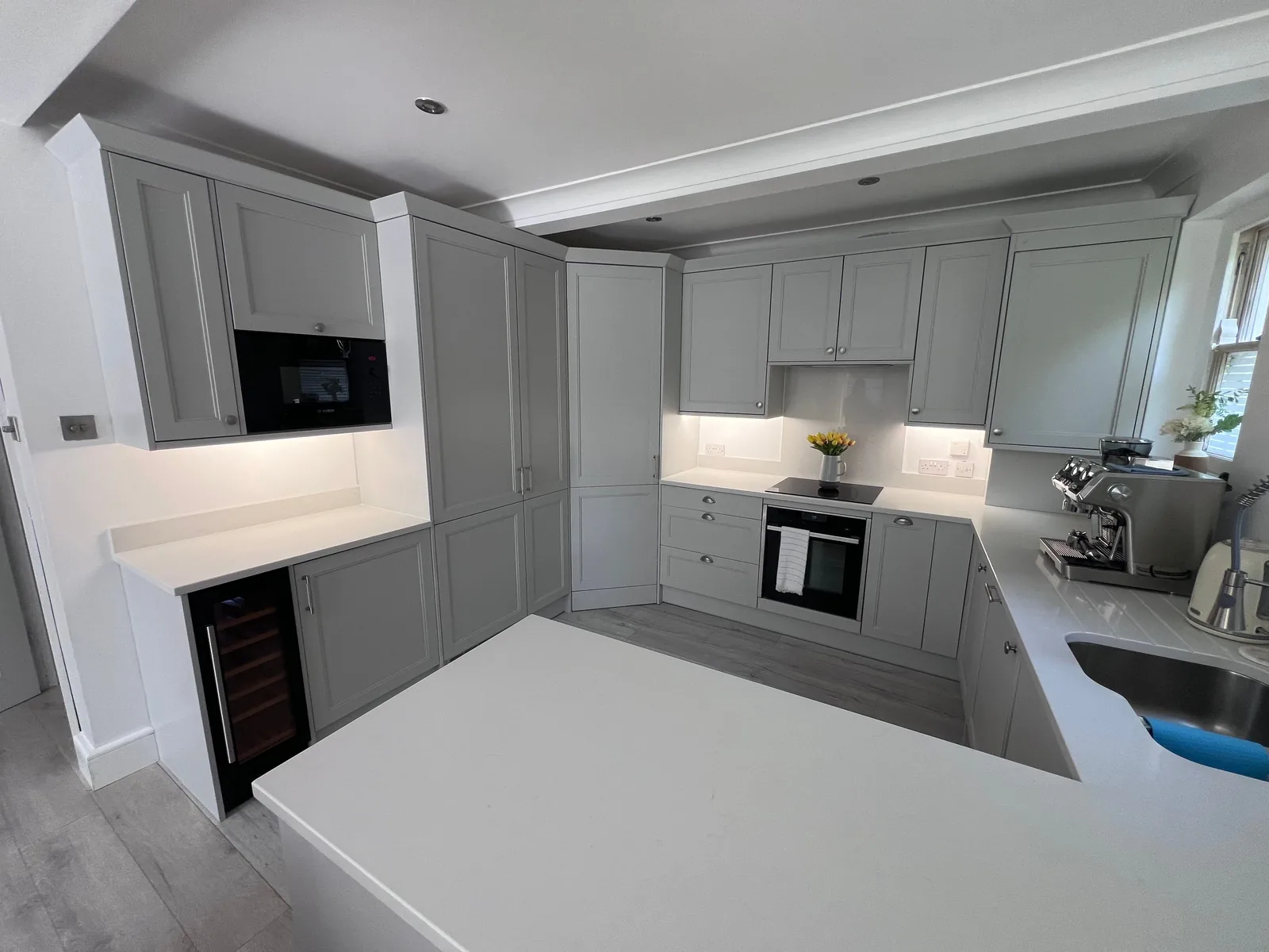 Light grey shaker kitchen with under-cabinet lighting
