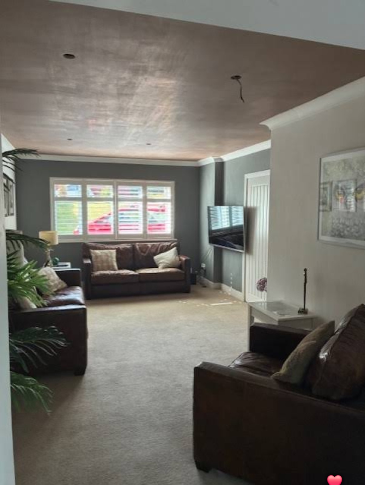 Freshly skimmed lounge ceiling above a finished sitting room