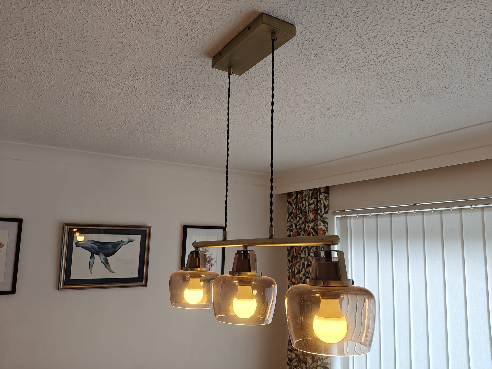Re-energize Electrical, Three light pendant fitted over a dining area