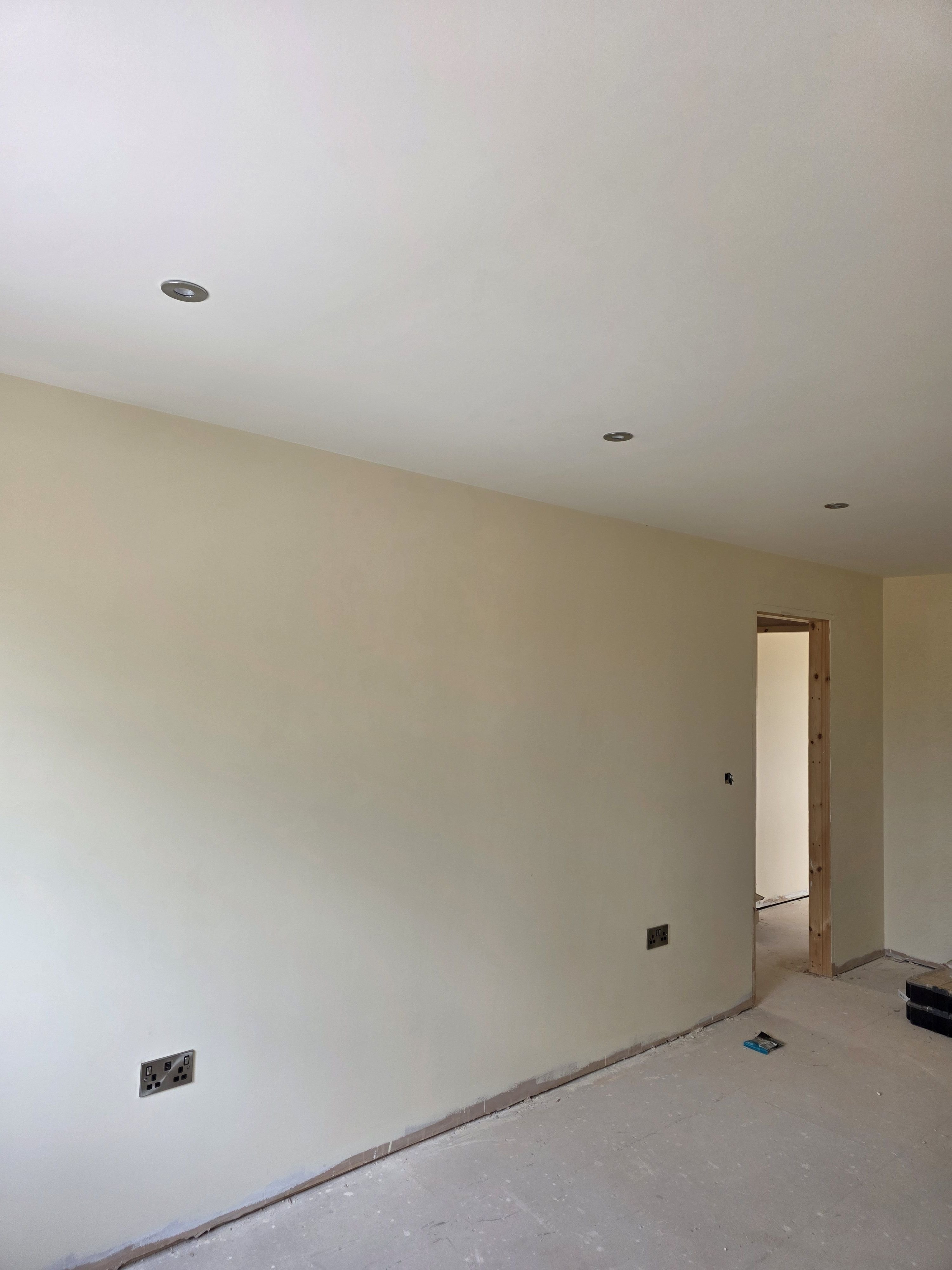 Newly decorated room with downlights and double sockets fitted